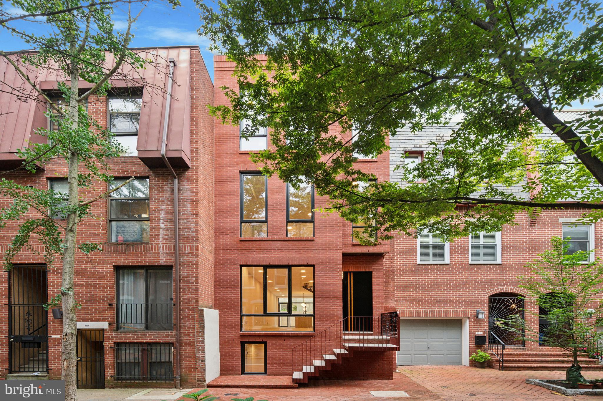 front view of a house with a tree