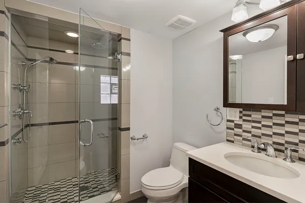 a bathroom with a sink toilet and shower