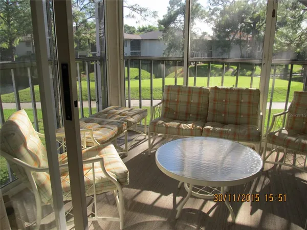 a view of a patio with table and chairs