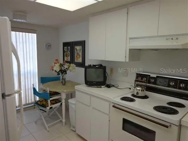 a kitchen with a stove and a refrigerator