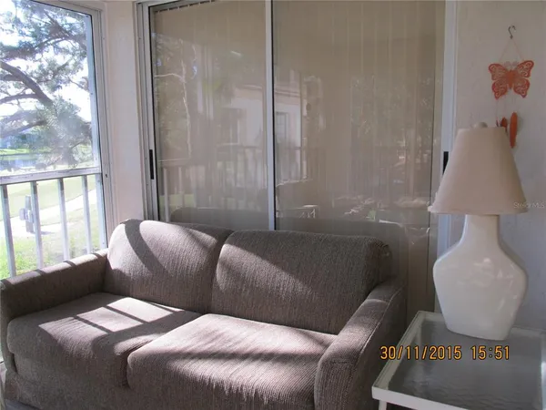 a balcony with furniture and a large window