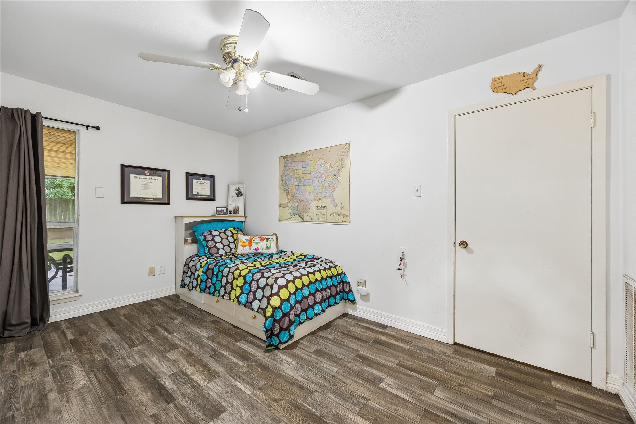 5526 Grape Street Houston, TX 77096 - Photo 9 of 10 a room with a bed and a chandelier