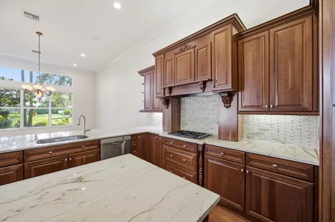 a kitchen with stainless steel appliances granite countertop a refrigerator and a sink