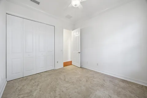 a front view of a house with a yard and potted plants