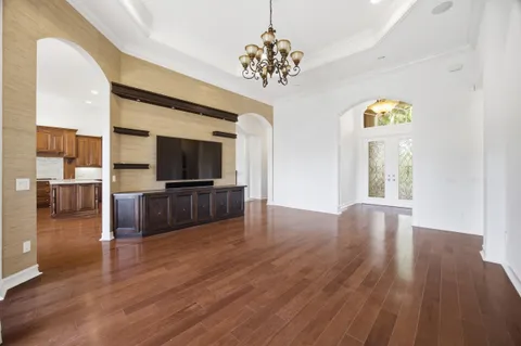 a kitchen with stainless steel appliances granite countertop a stove a refrigerator a sink and a oven with wooden floor