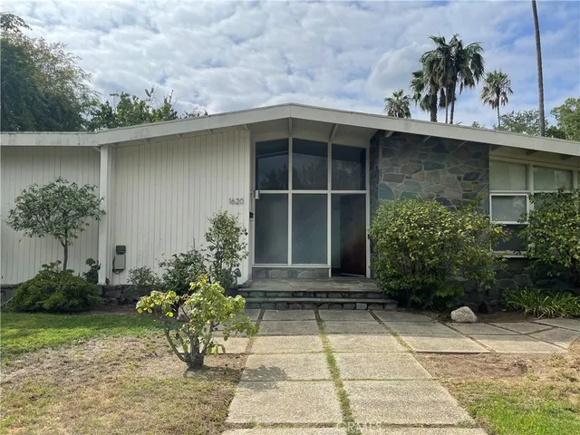 a couple of potted plants in front of door
