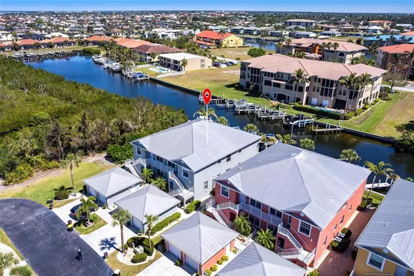 an aerial view of a house with swimming pool and ocean view
