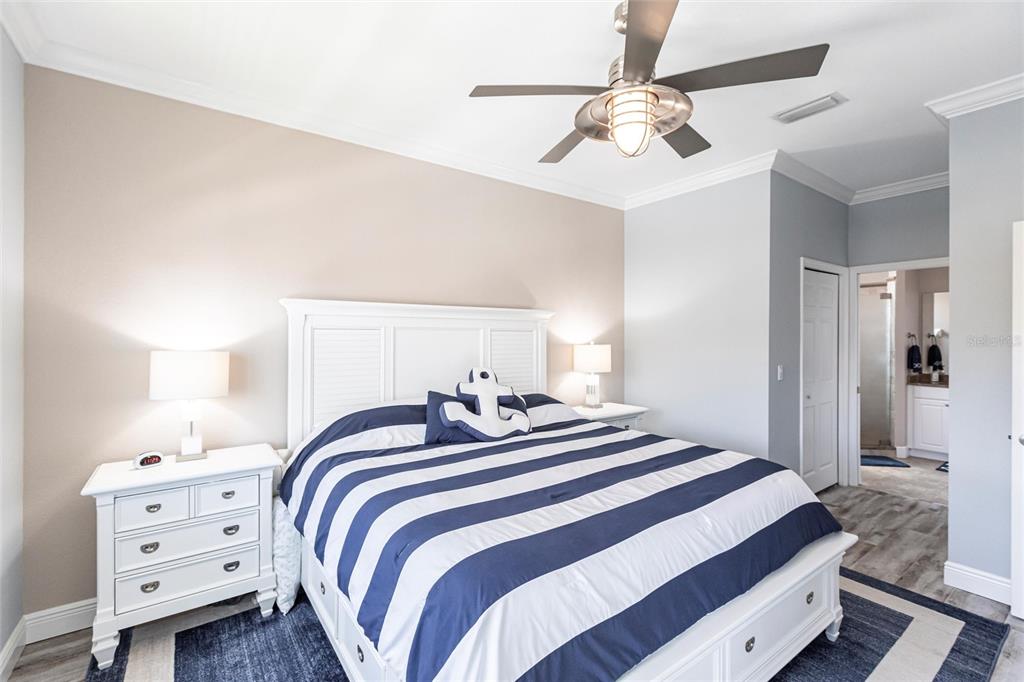 2002 Bal Harbor Boulevard, Unit 1022 Punta Gorda, FL 33950 - Photo 11 of 32 a bedroom with a bed and a chandelier