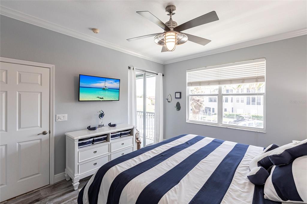 2002 Bal Harbor Boulevard, Unit 1022 Punta Gorda, FL 33950 - Photo 12 of 32 a bedroom with a bed a window and a flat screen tv