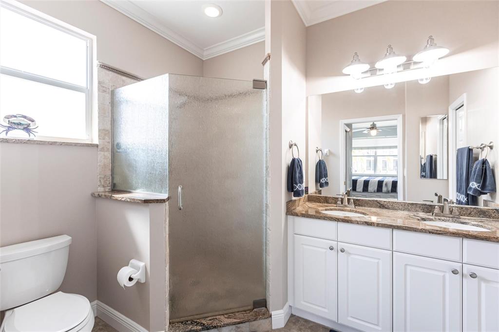 2002 Bal Harbor Boulevard, Unit 1022 Punta Gorda, FL 33950 - Photo 13 of 32 a bathroom with a toilet sink and mirror