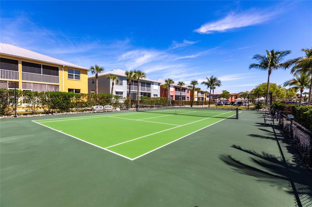 2002 Bal Harbor Boulevard, Unit 1022 Punta Gorda, FL 33950 - Photo 30 of 32 a view of a tennis ground with large trees