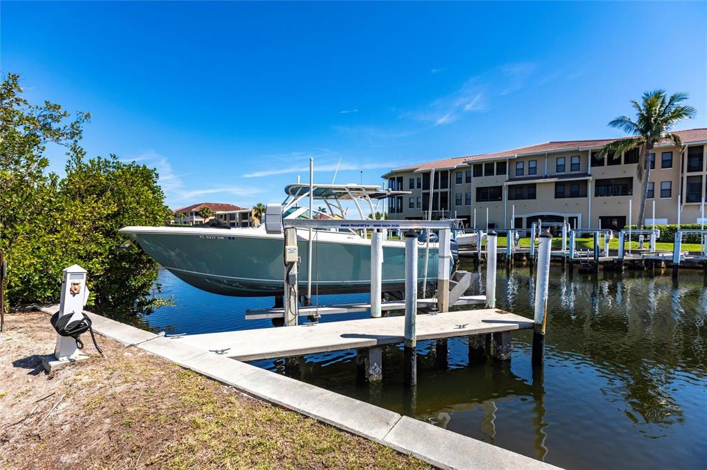 2002 Bal Harbor Boulevard, Unit 1022 Punta Gorda, FL 33950 - Photo 3 of 32 a view of a house with pool and chairs