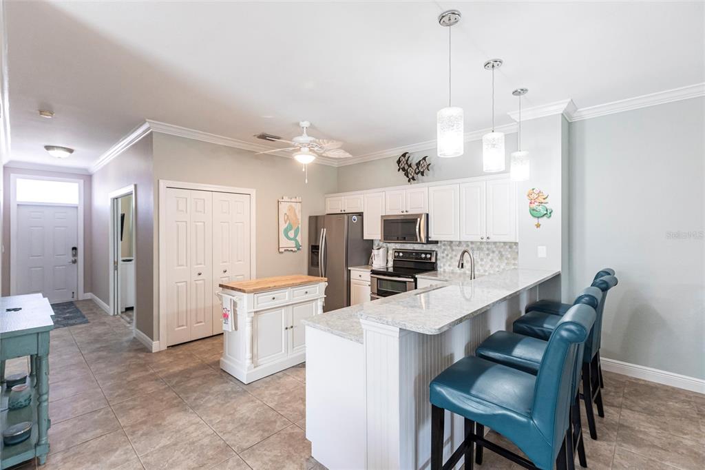 2002 Bal Harbor Boulevard, Unit 1022 Punta Gorda, FL 33950 - Photo 4 of 32 a large kitchen with a table and chairs