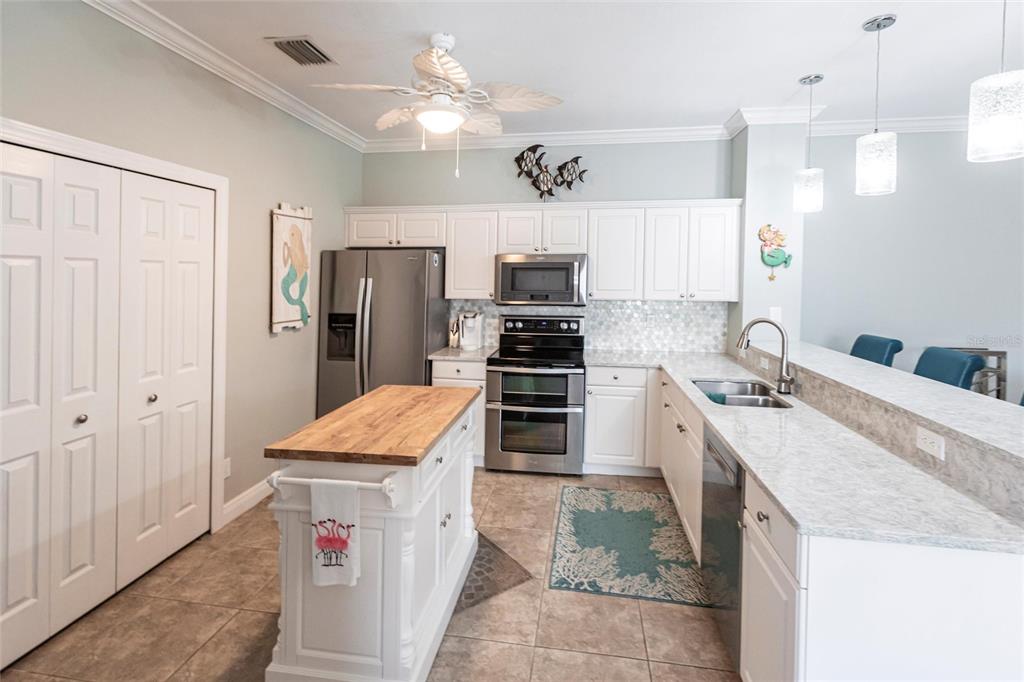 2002 Bal Harbor Boulevard, Unit 1022 Punta Gorda, FL 33950 - Photo 5 of 32 a kitchen with a sink stove and refrigerator