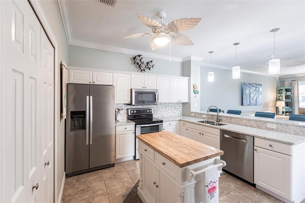 2002 Bal Harbor Boulevard, Unit 1022 Punta Gorda, FL 33950 - Photo 6 of 32 a kitchen with a sink a stove a refrigerator and a refrigerator