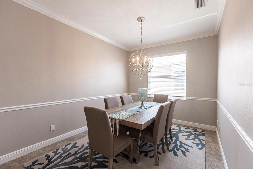 2002 Bal Harbor Boulevard, Unit 1022 Punta Gorda, FL 33950 - Photo 10 of 32 a view of a dining room with furniture window and wooden floor