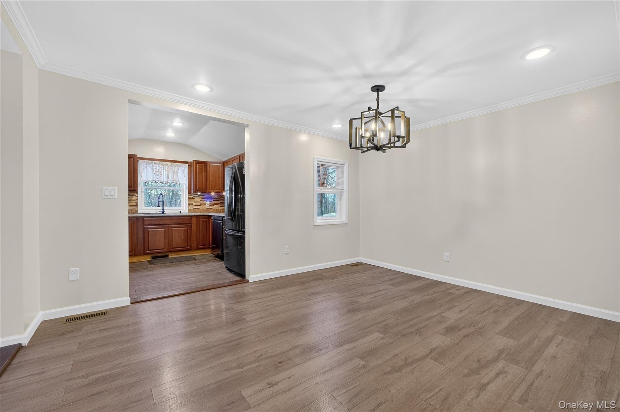 173 North Grand Avenue Poughkeepsie, NY 12603 - Photo 11 of 33 an empty room with wooden floor and windows