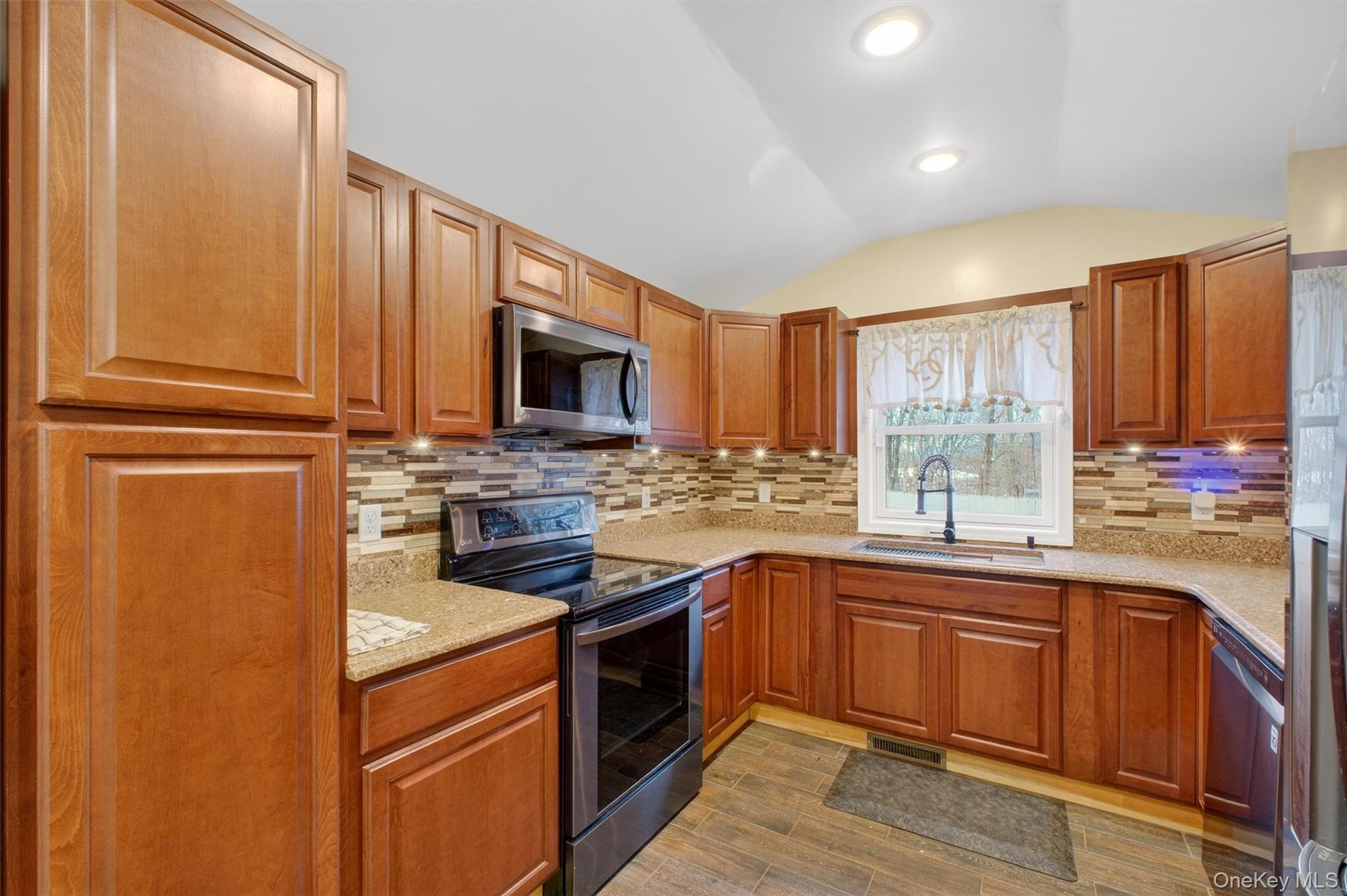 173 North Grand Avenue Poughkeepsie, NY 12603 - Photo 13 of 33 a kitchen with stainless steel appliances granite countertop a stove a sink dishwasher and a microwave oven with cabinets