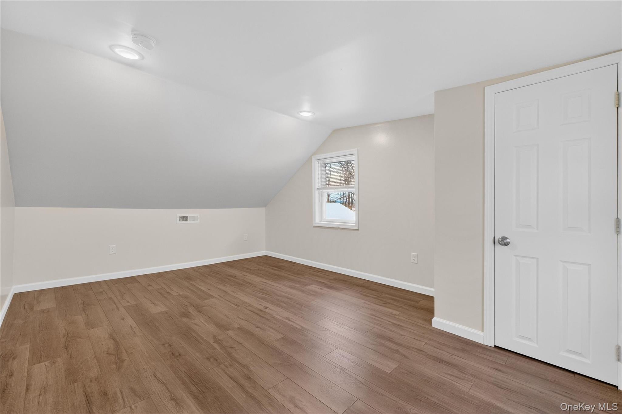 173 North Grand Avenue Poughkeepsie, NY 12603 - Photo 20 of 33 an empty room with wooden floor and windows