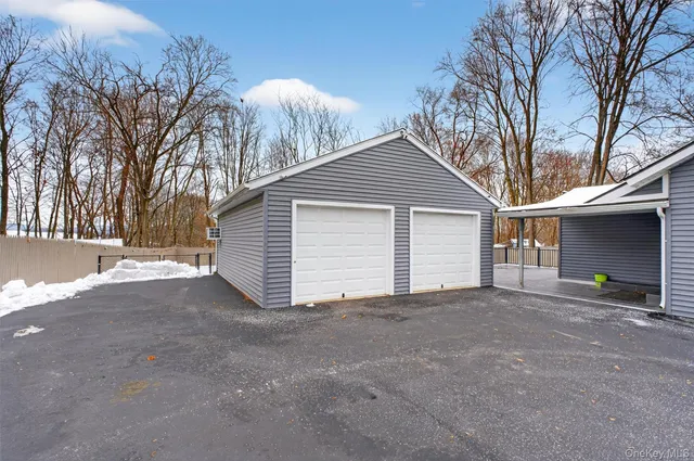 a view of a house with a yard and garage