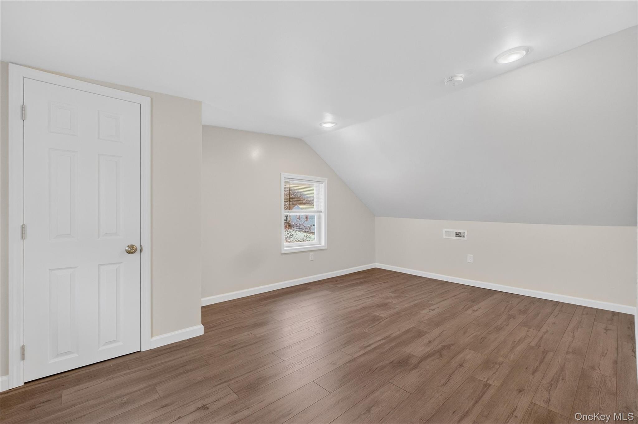 173 North Grand Avenue Poughkeepsie, NY 12603 - Photo 21 of 33 an empty room with wooden floor and windows