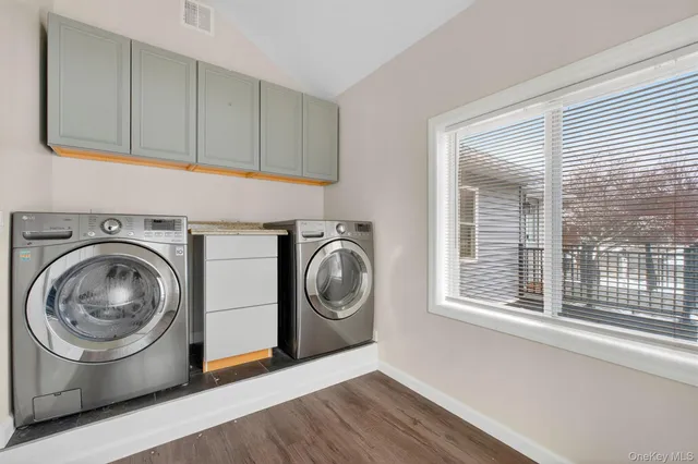 a utility room with sink dryer and washer