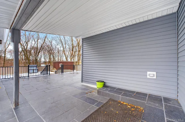 a backyard of a house with table and chairs