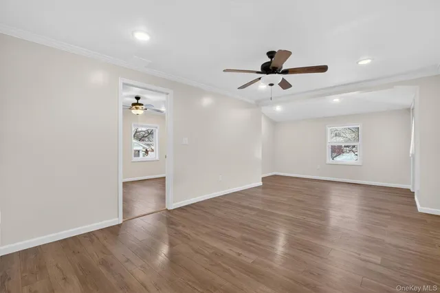 wooden floor in an empty room with a window