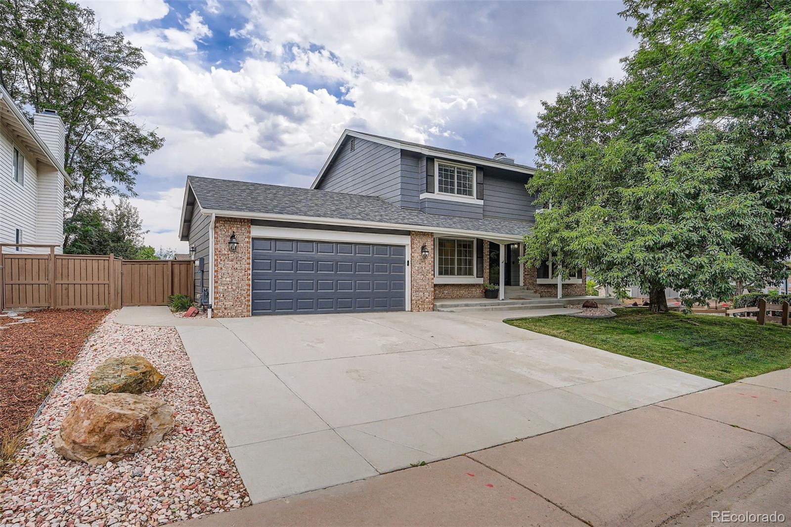 202 Northridge Road Highlands Ranch, CO 80126 - Photo 1 of 37 a front view of a house with a yard and garage