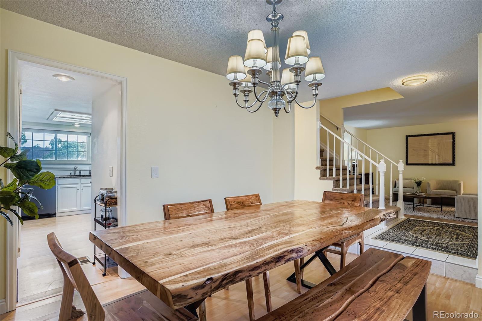 202 Northridge Road Highlands Ranch, CO 80126 - Photo 11 of 37 a view of a dining room with furniture a chandelier and wooden floor