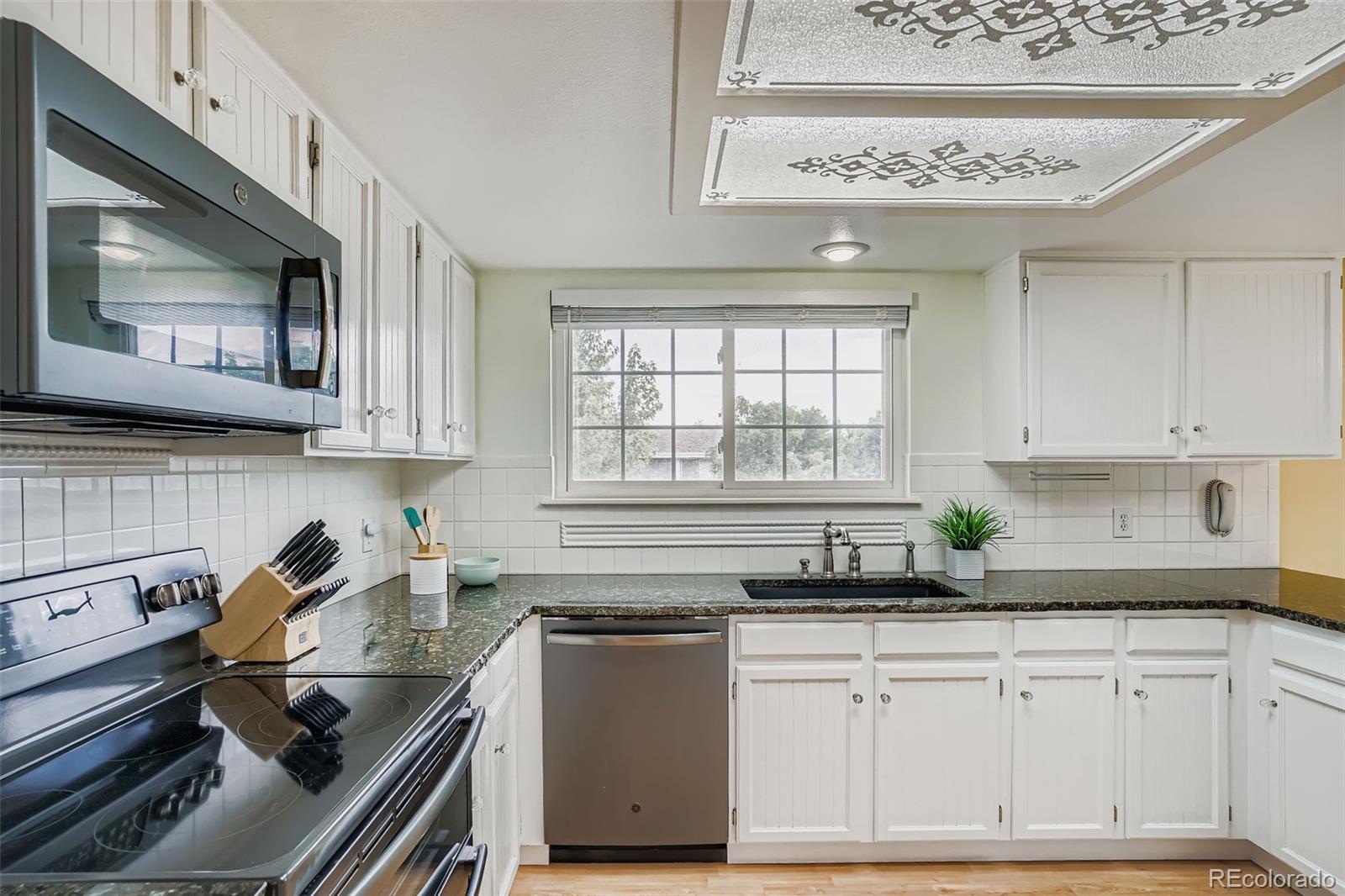 202 Northridge Road Highlands Ranch, CO 80126 - Photo 17 of 37 a kitchen with a sink stove and cabinets