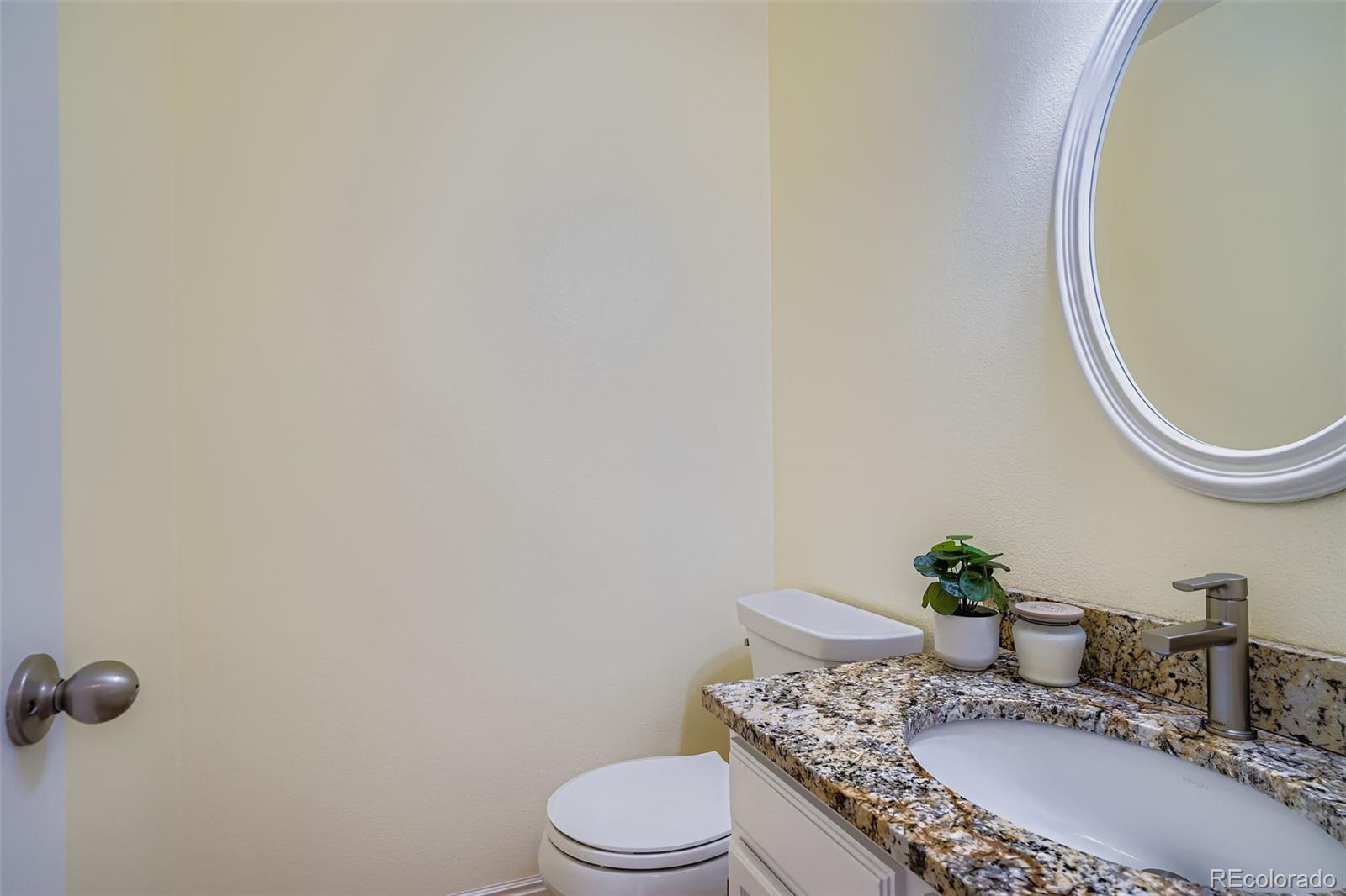 202 Northridge Road Highlands Ranch, CO 80126 - Photo 19 of 37 a bathroom with a granite countertop sink and a mirror