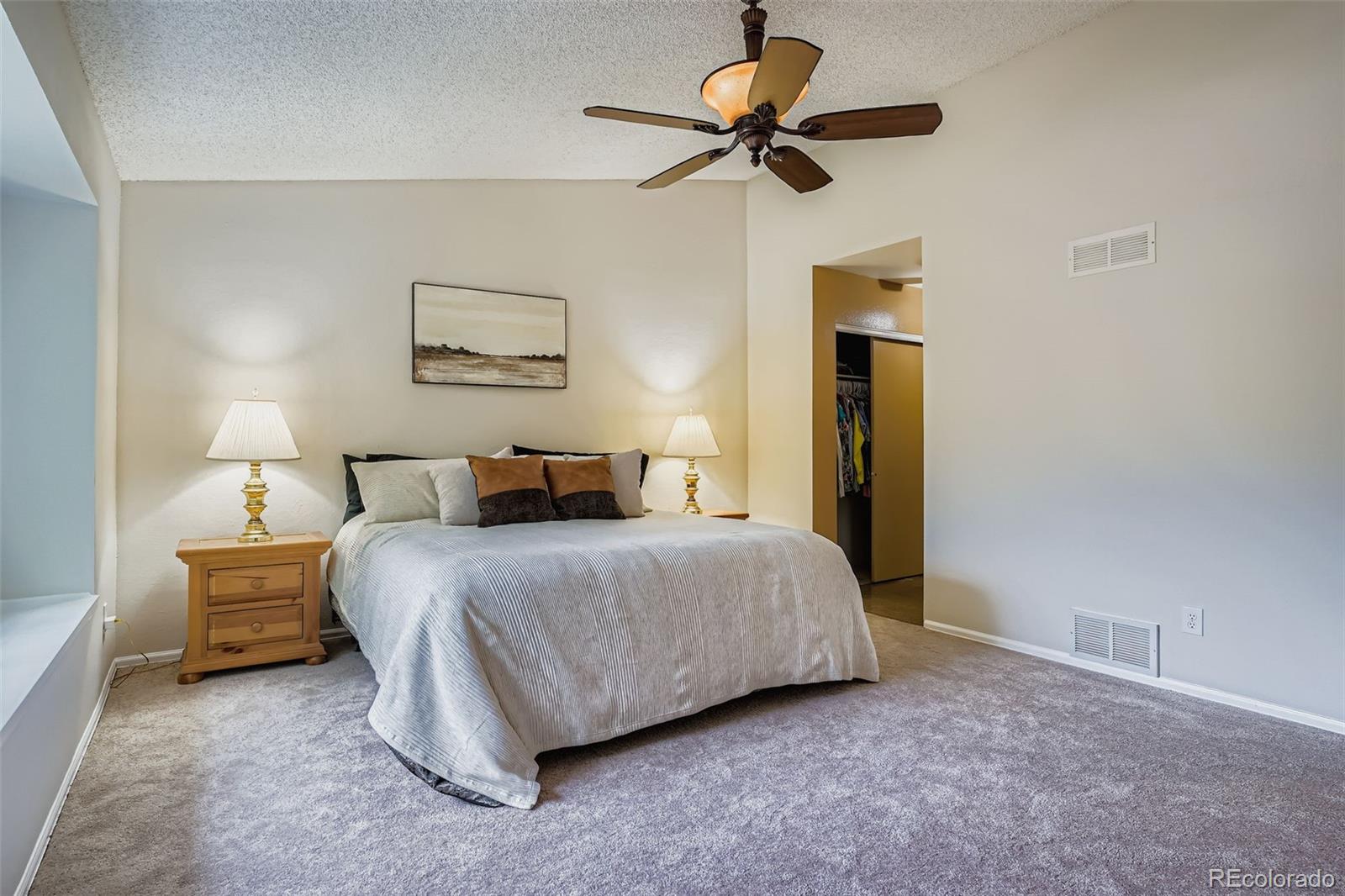 202 Northridge Road Highlands Ranch, CO 80126 - Photo 21 of 37 a bedroom with a bed a lamp and a chandelier