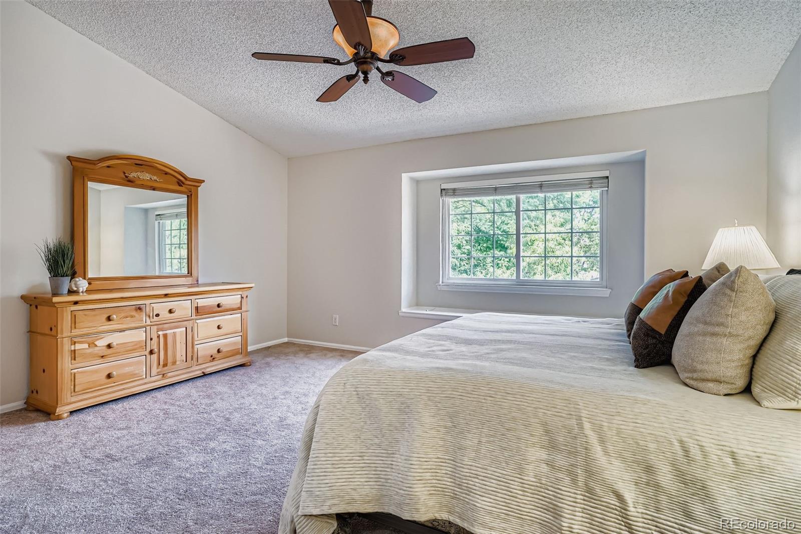 202 Northridge Road Highlands Ranch, CO 80126 - Photo 22 of 37 a bedroom with a bed and a dresser