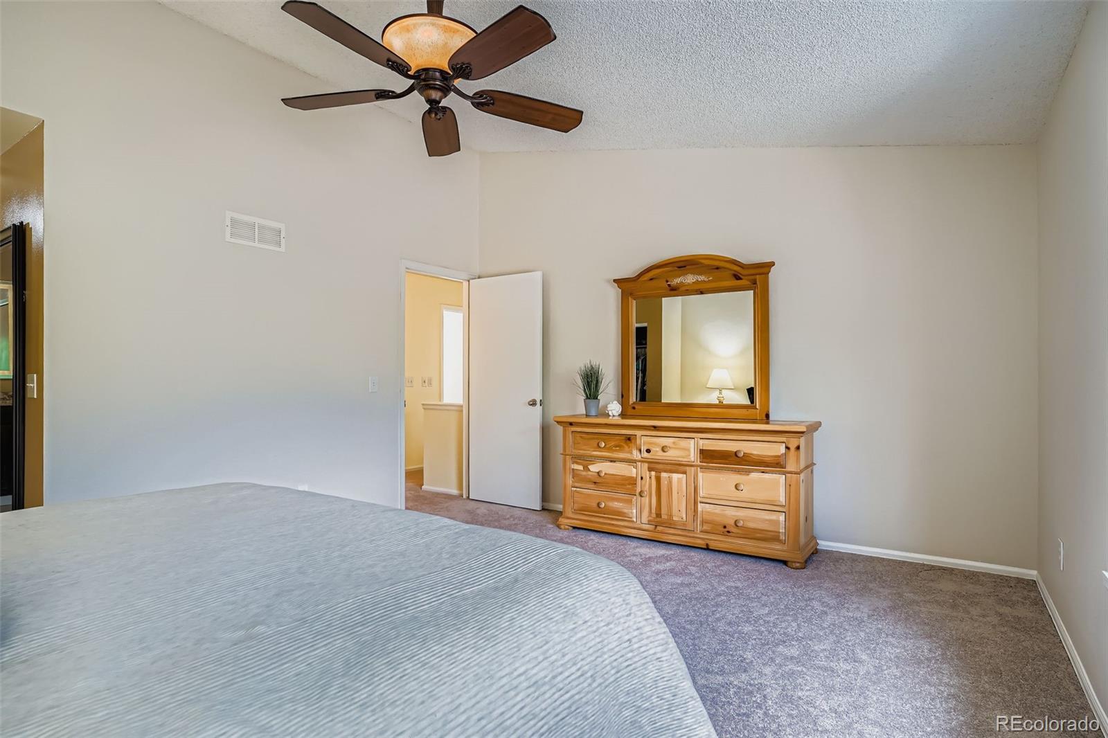 202 Northridge Road Highlands Ranch, CO 80126 - Photo 23 of 37 a bedroom with a bed and a chandelier