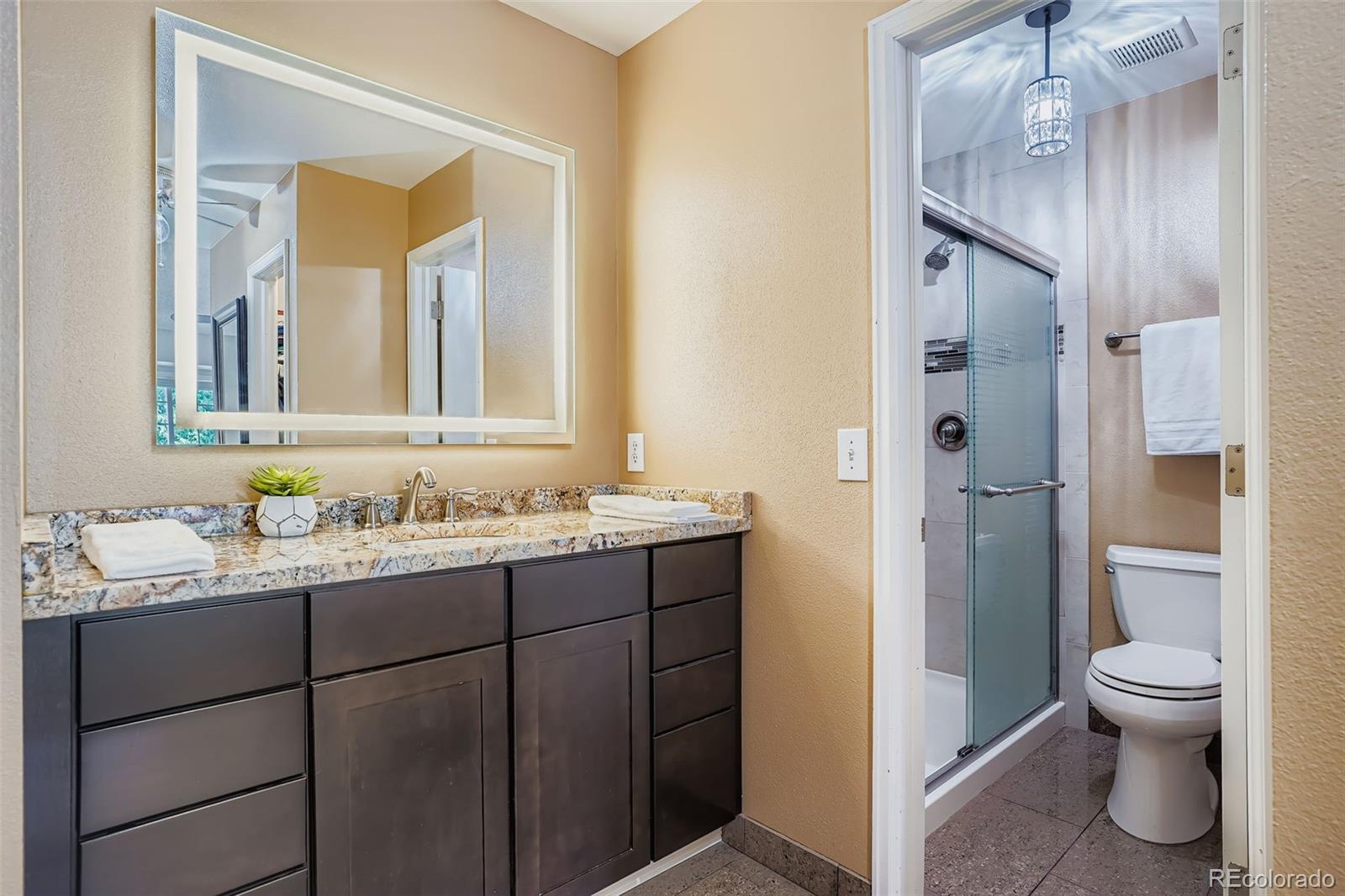 202 Northridge Road Highlands Ranch, CO 80126 - Photo 25 of 37 a bathroom with a granite countertop sink toilet and shower