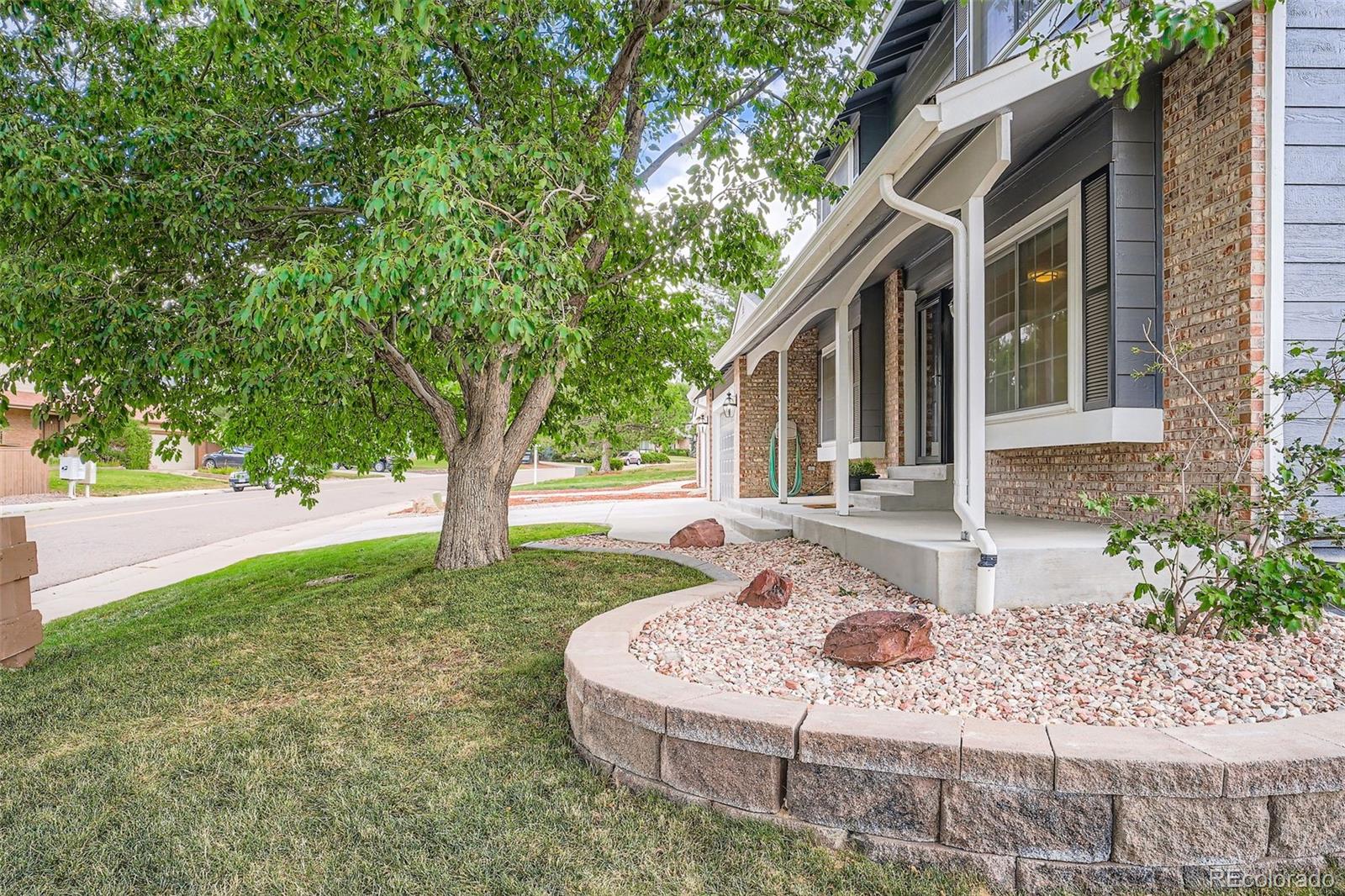 202 Northridge Road Highlands Ranch, CO 80126 - Photo 3 of 37 a front view of a house with garden