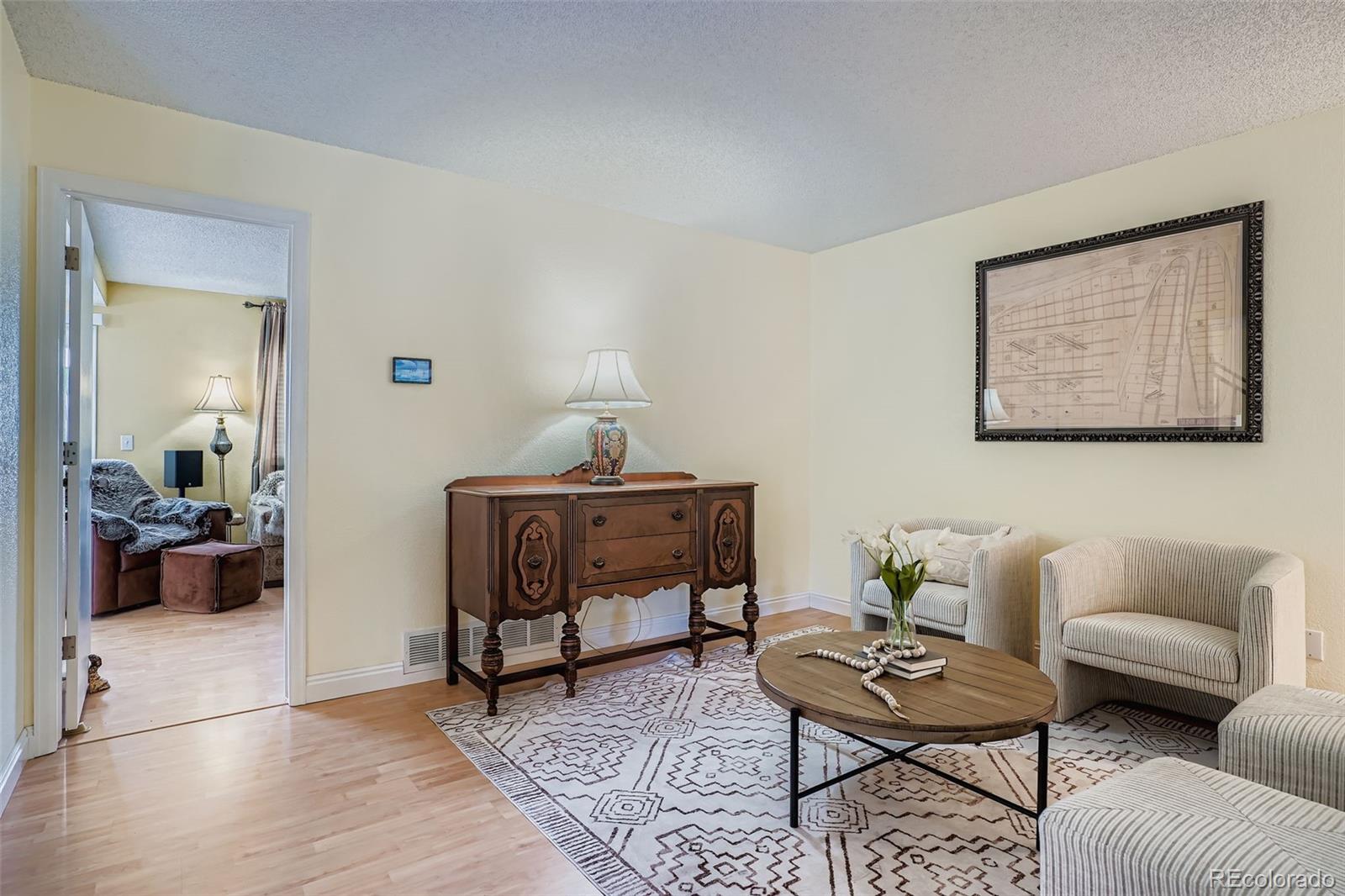 202 Northridge Road Highlands Ranch, CO 80126 - Photo 5 of 37 a living room with furniture and wooden floor