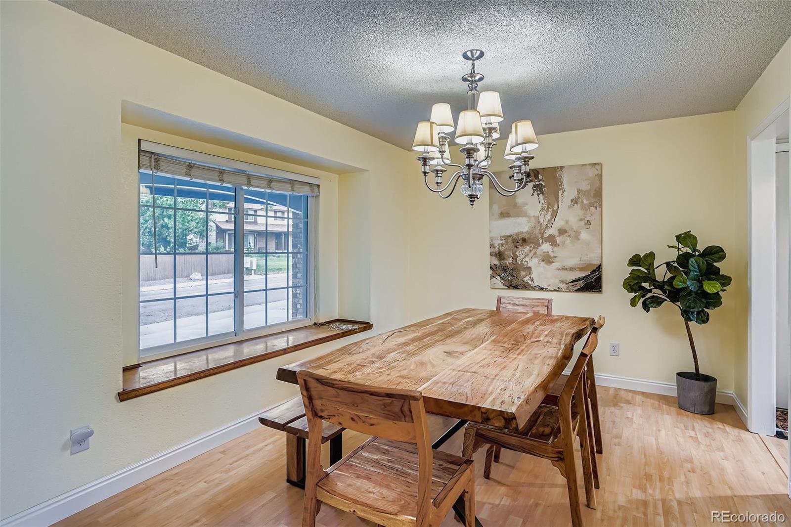 202 Northridge Road Highlands Ranch, CO 80126 - Photo 9 of 37 a view of a dining room with furniture and a chandelier