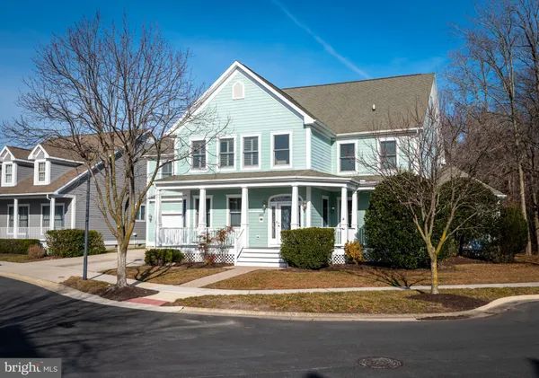 a hallway with a dining table and chairs with wooden floor