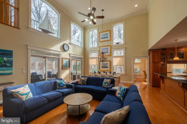 a living room with lots of furniture and kitchen view
