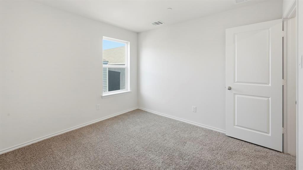206 Redwood Road Princeton, TX 75407 - Photo 21 of 40 a view of an empty room with a window