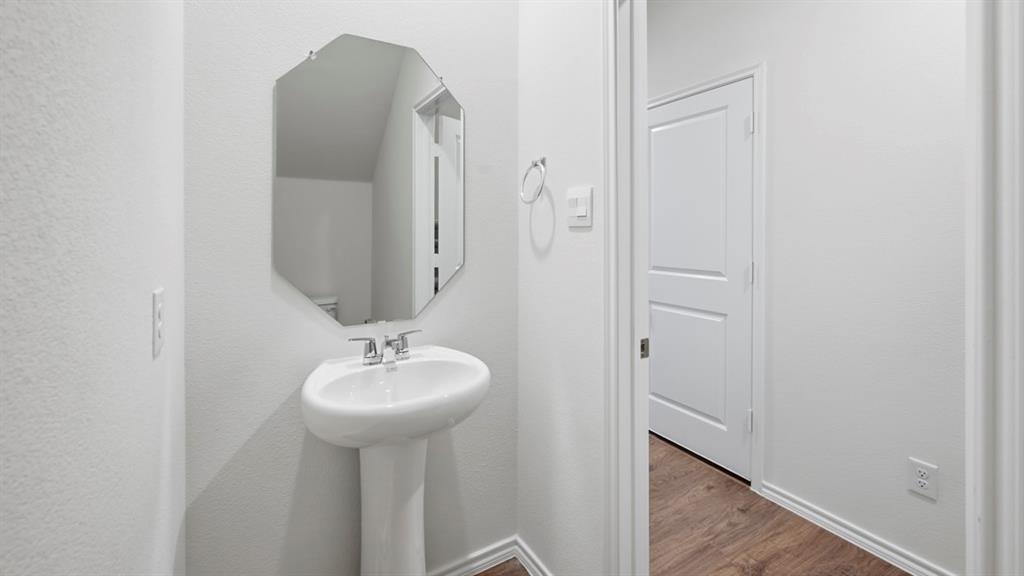 206 Redwood Road Princeton, TX 75407 - Photo 4 of 40 a bathroom with a sink and a mirror