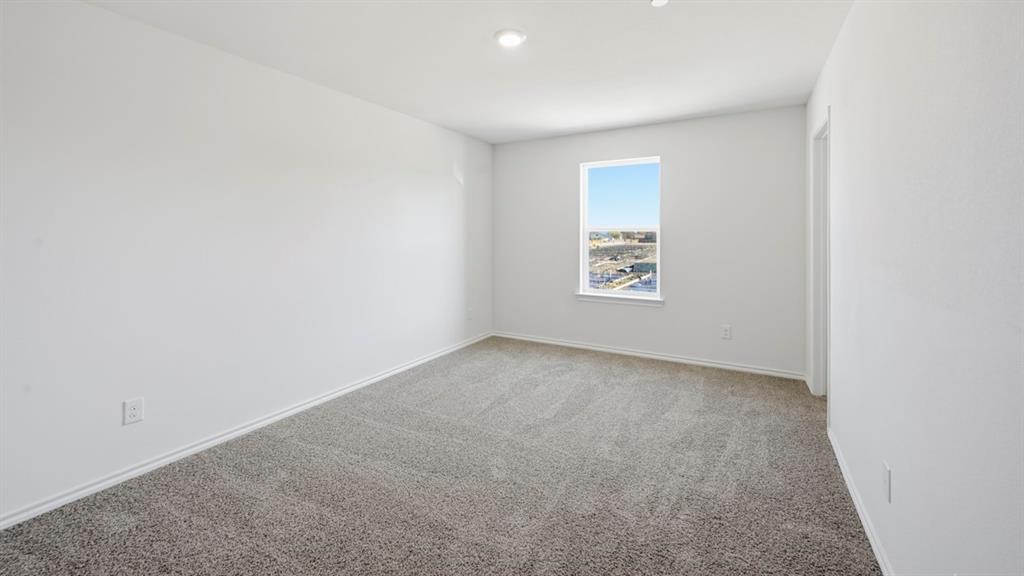 206 Redwood Road Princeton, TX 75407 - Photo 8 of 40 a view of an empty room and a window