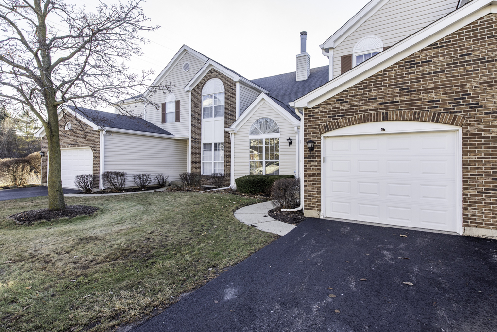 1834 Arbor Court Gurnee, IL 60031 - Photo 30 of 31 a front view of a house with a yard and garage