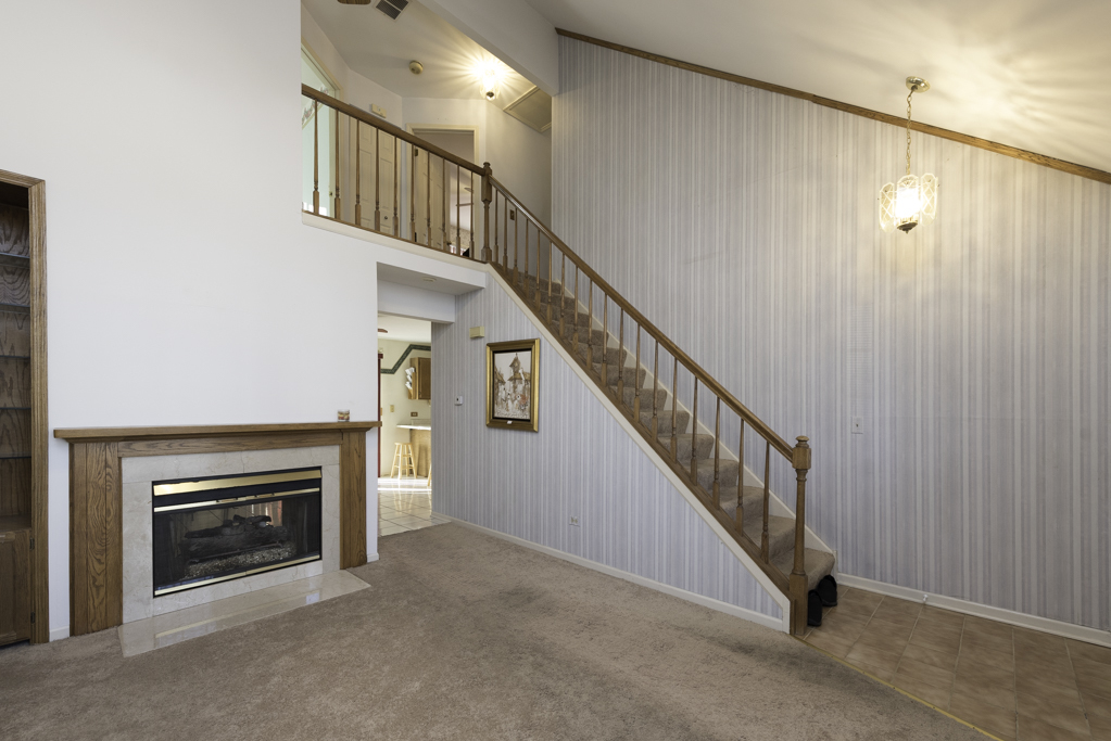 1834 Arbor Court Gurnee, IL 60031 - Photo 3 of 31 a view of entryway and hall with a fireplace