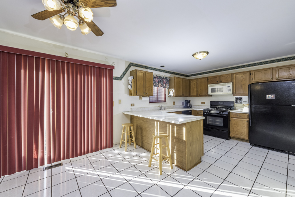 1834 Arbor Court Gurnee, IL 60031 - Photo 7 of 31 a kitchen with a sink cabinets and appliances