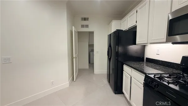 a kitchen with stainless steel appliances a refrigerator and a stove