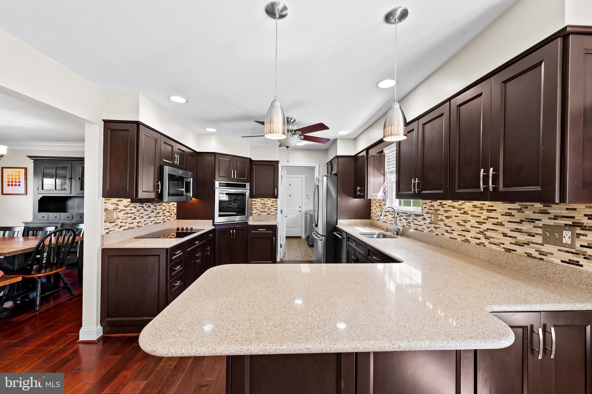 14305 Robcaste Road Phoenix, MD 21131 - Photo 13 of 53 a kitchen with stainless steel appliances granite countertop a sink a stove and a refrigerator
