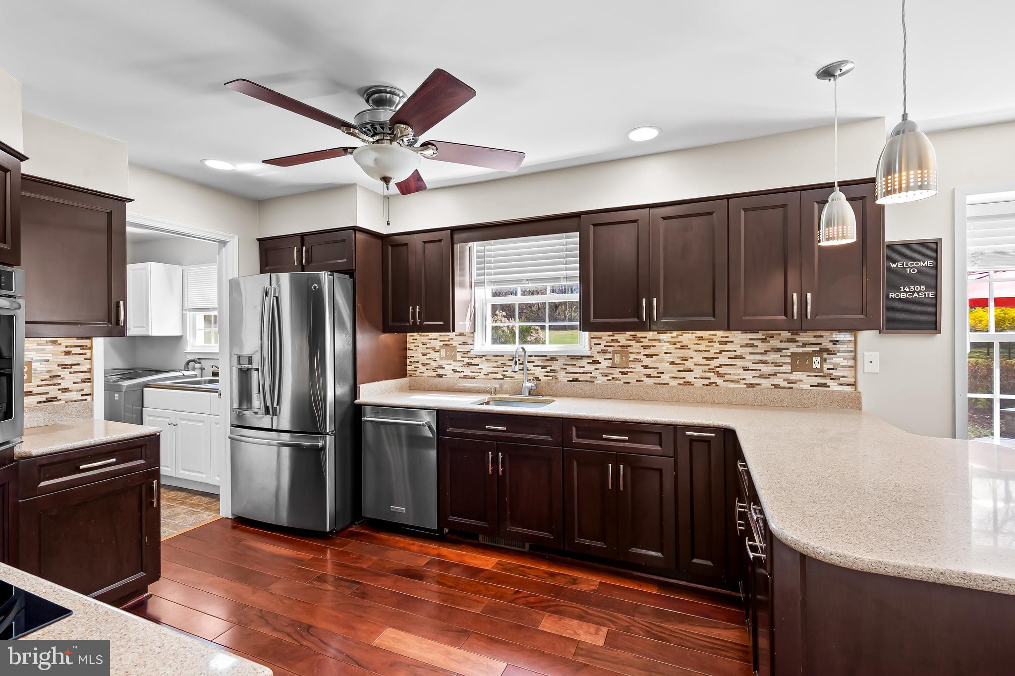 14305 Robcaste Road Phoenix, MD 21131 - Photo 15 of 53 a kitchen with stainless steel appliances kitchen island granite countertop a refrigerator a sink and dishwasher